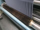 a close up of a machine that is working on a piece of fabric