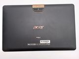 the back of a black laptop with a gold handle on a white surface