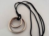a close up of a necklace with two rings on it