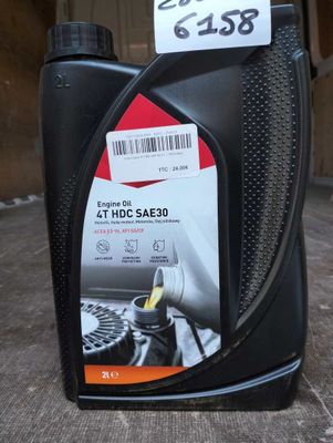 a bottle of engine oil sitting on the floor