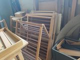 a lot of wooden chairs and a table in a room
