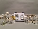 a lot of silver and glass bottles sitting on a table