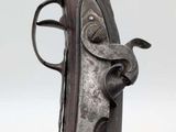 a close up of a gun that is on display on a table
