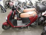 many scooters that are parked in a garage
