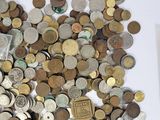 a pile of coins on a table next to a picture frame