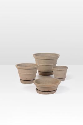 quatre petits pots en argile empilés les uns sur les autres sur une table