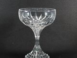 a close up of a glass cup on a black surface