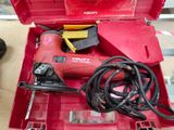 a red tool box with tools in it sitting on a table