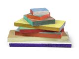 a stack of colorful blocks on a white surface