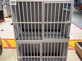 a metal cage that is sitting on a pallet in a warehouse