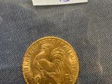 a close up of a gold coin with a label on it