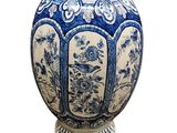 a blue and white vase sitting on a pedestal