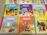 several children ' s books are lined up on the floor