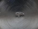 an old silver plate with two elephants on it sitting on a table