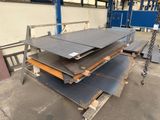 some steel plates are stacked on top of each other in a warehouse