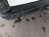 a close up of a car ' s bumper with a small hole in the bumper