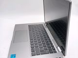 a silver laptop with a black keyboard on a white surface