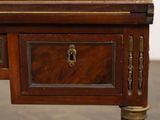 a small wooden desk with a drawer on top of it