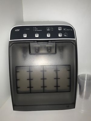 an image of a coffee machine with a cup in front of it