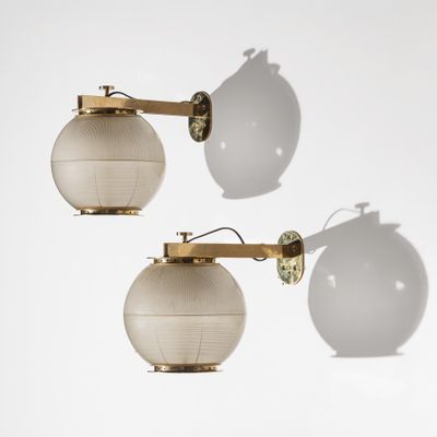 a pair of brass and glass wall lights