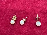 une paire de boucles d'oreilles en perles posées sur un fond de velours rouge