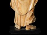 a statue of a man in a robe holding a book