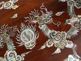 a wooden table with a dragon design on it