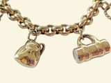 a gold bracelet with two charms on it