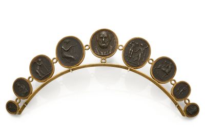 a close up of a gold tia with black and white images on it
