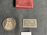 a small coin and a small wallet on a table