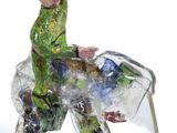 figurine of a man riding a horse with a plastic cover on its back