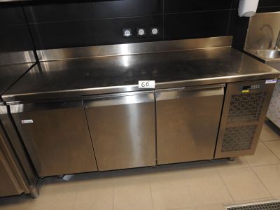 un plan de travail en acier inoxydable dans une cuisine équipée d'un réfrigérateur et d'un lave-vaisselle