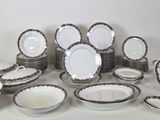 a lot of plates and bowls sitting on a table