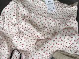a pile of underwear sitting on top of a table next to a bag