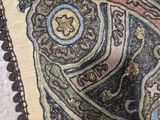 a close up of a decorative pillow on a table