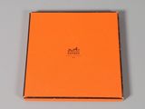 an orange box with a logo on it sitting on top of a table