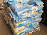 a pile of toilet paper on a pallet next to a truck