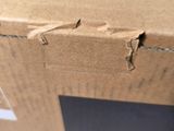 a close up of a cardboard box with a hole in it