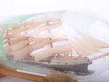 a ship in a bottle on a wooden stand