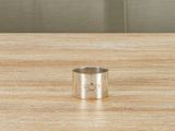 an image of a silver ring on a wooden table