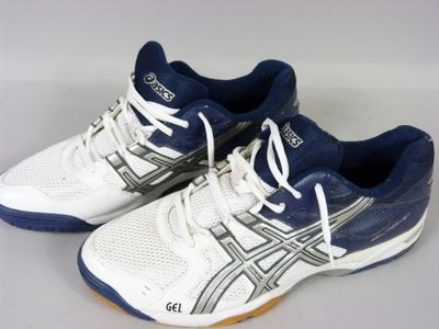 white and blue asics tennis shoes on a white surface