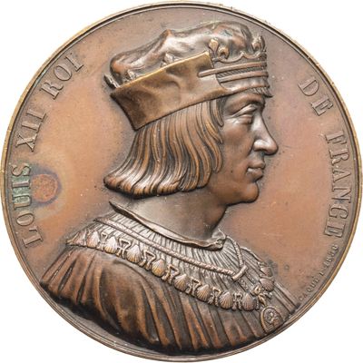une vieille médaille en bronze sur laquelle figure un homme coiffé d'une couronne