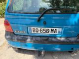 a blue car that is parked on the side of the road