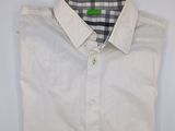 the shirt is white and has a checkered collar