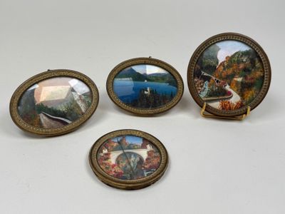 four miniature picture frames with a picture of a lake and a boat