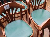 six wooden chairs are lined up in a row on a wooden floor