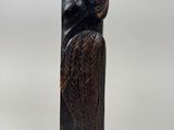an image of a sculpture of an owl on a wooden block