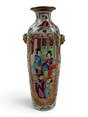 a vase with a painting on it sitting on a table