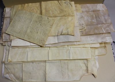 several pieces of old paper sitting on top of a table