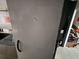a white refrigerator in a kitchen with tile flooring